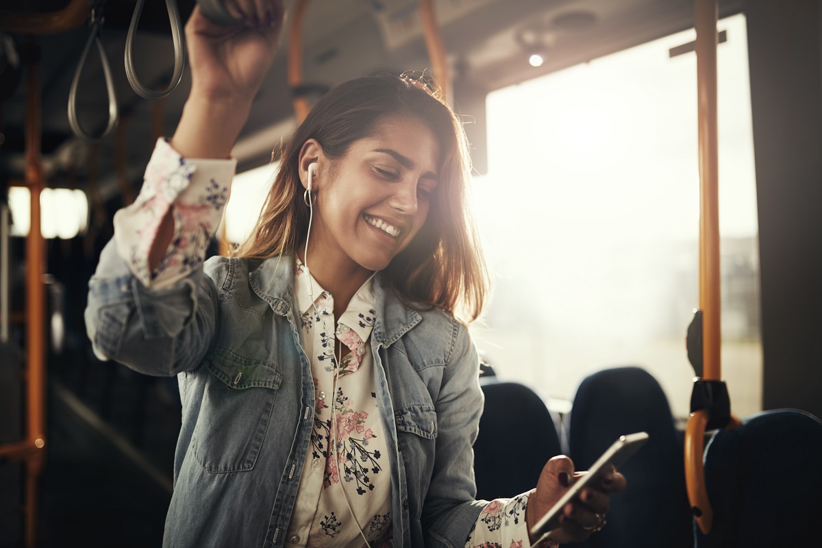 woman listening to music while on transit