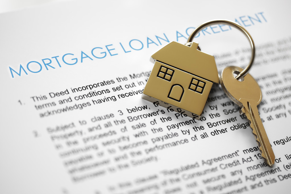 A mortgage loan agreement with house key and house-shaped keyring