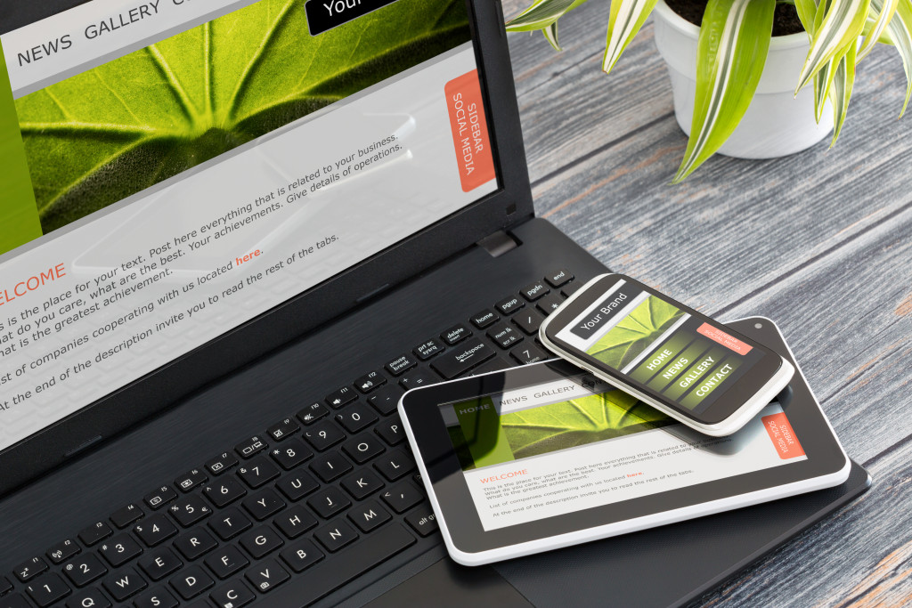 web design being shown on mobile phone, tablet, and laptop