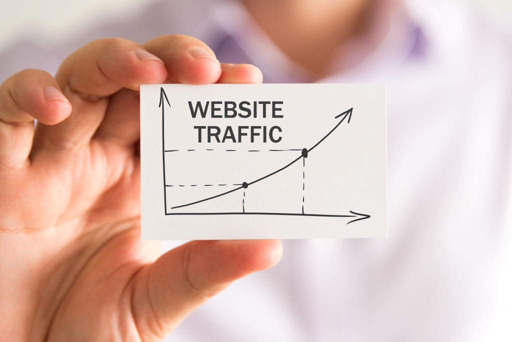 Man holding paper with website traffic graph